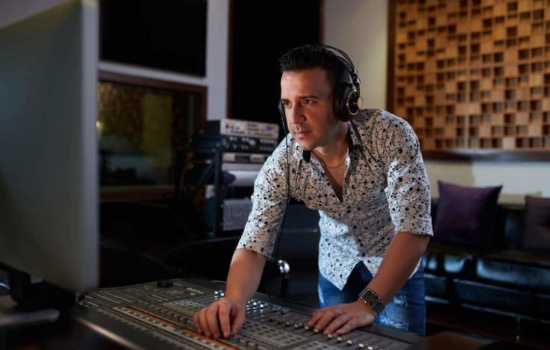 Music Editor behind the soundboard while watching the film he's working on