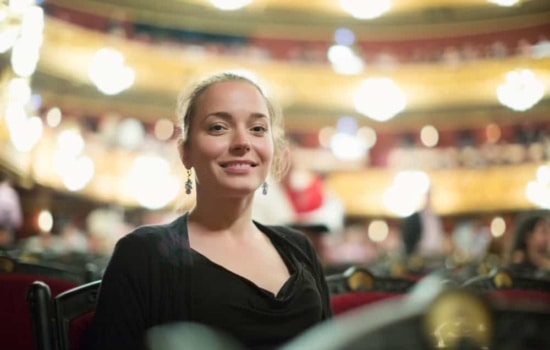 Concert Hall Marketing Director sitting in auditorium of opera theater