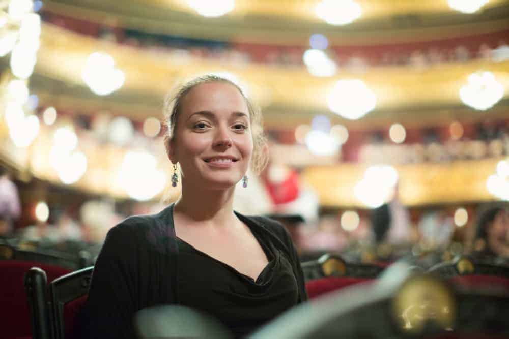 Concert Hall Marketing Director sitting in auditorium of opera theater