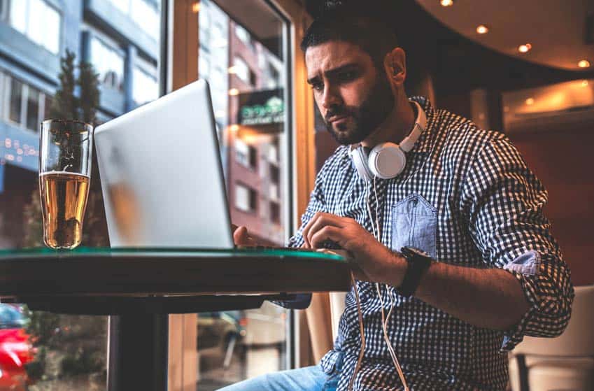 Concert Promoter on his laptop at a bar