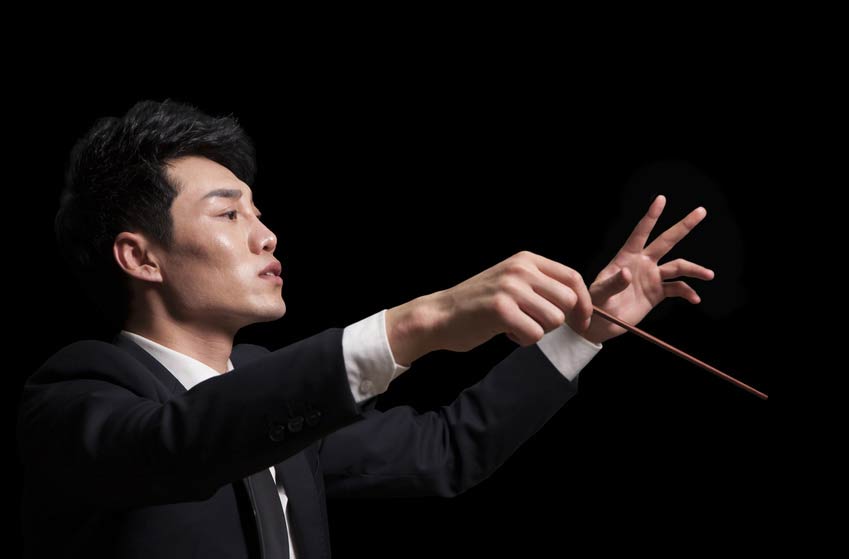 Handsome Asian male Conductor in closeup