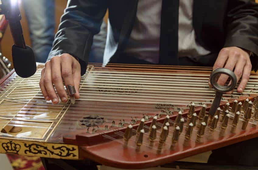 Ethnomusicologist performing on stringed instrument