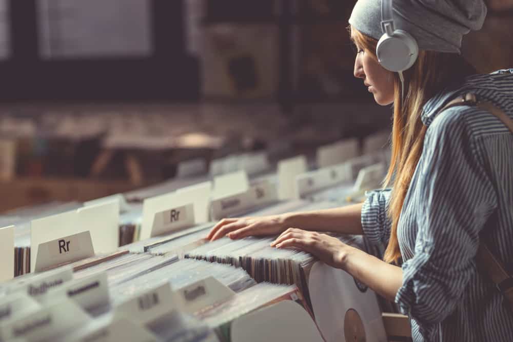 Young Field Merchandiser with headphones in music store