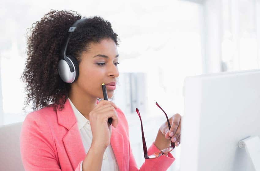 Music Publisher listening to music through headphones in her office