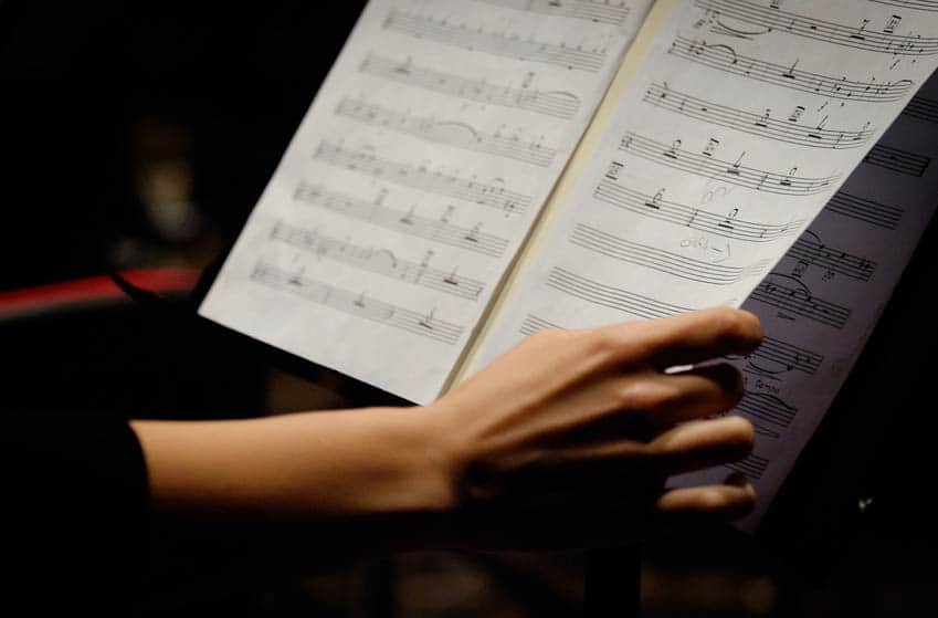 Orchestral Music Librarian turning pages of a score