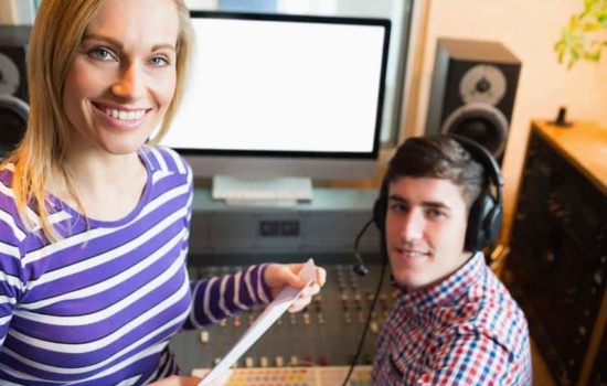 Program Director talking to DJ in the radio station studio