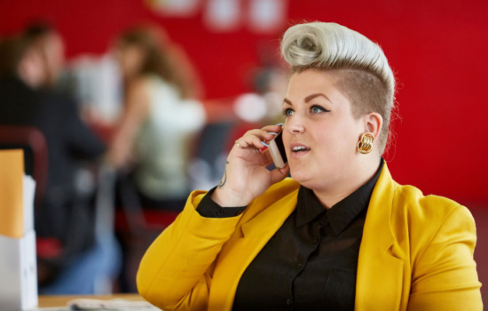Promotion manager talking on the phone with a contact