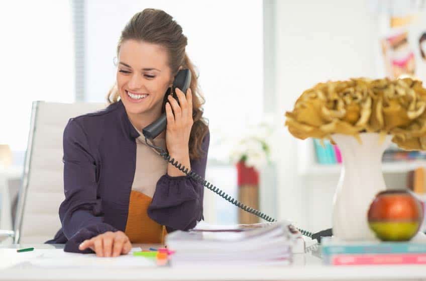 Music publicist on the phone with the media in her office