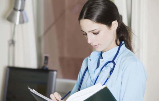 Speech Pathologist writing notes on a medical report