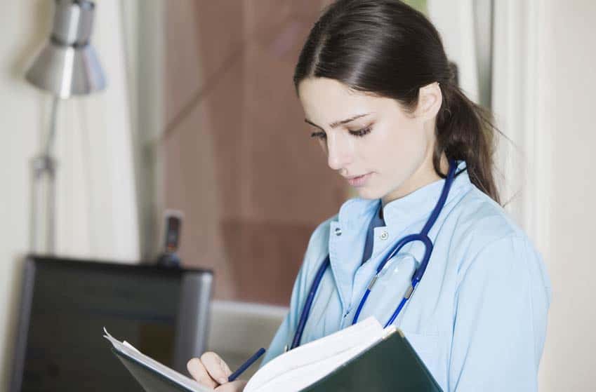 Speech Pathologist writing notes on a medical report