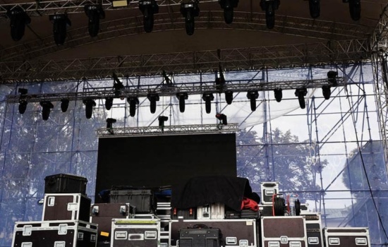 Musical gear in flight boxes on outdoor concert stage