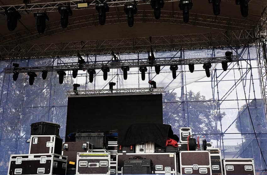 Musical gear in flight boxes on outdoor concert stage