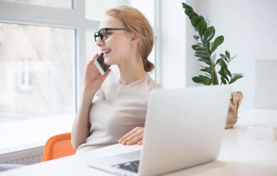 Tour publicist closing a deal on the phone in her office