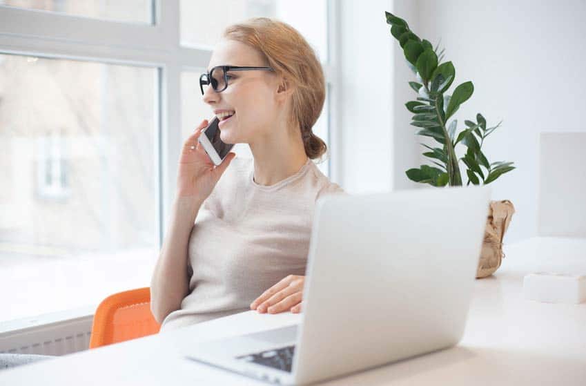 Tour publicist closing a deal on the phone in her office