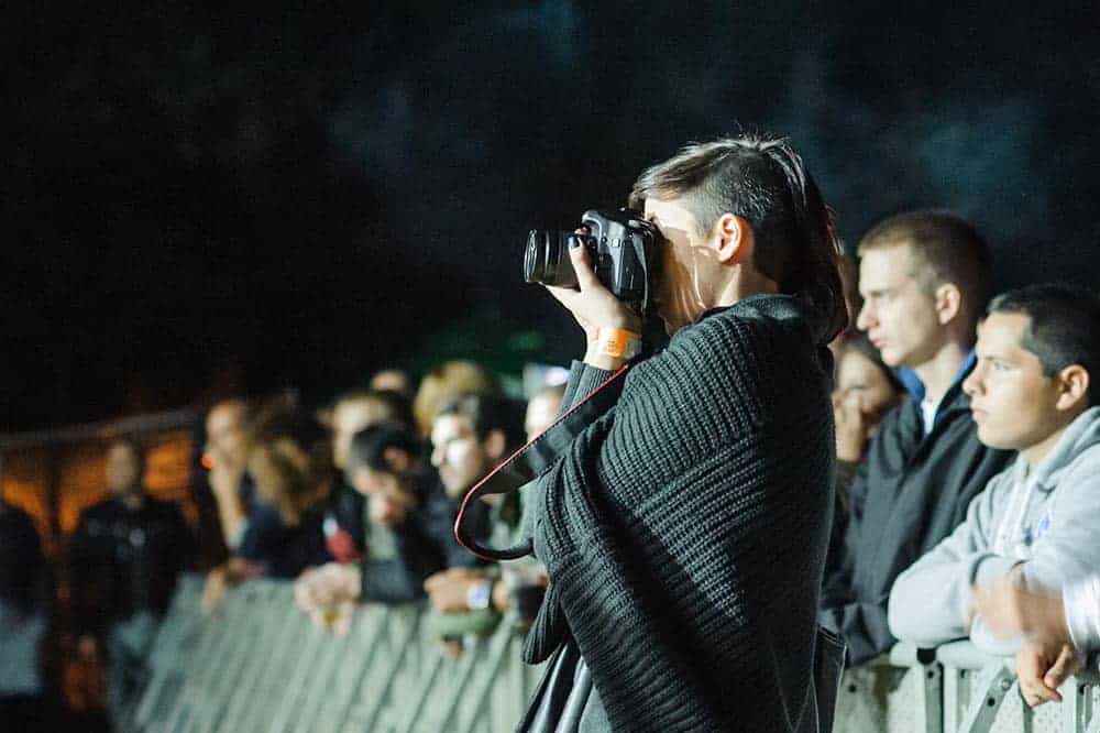 Female music photographer taking shots at a festival