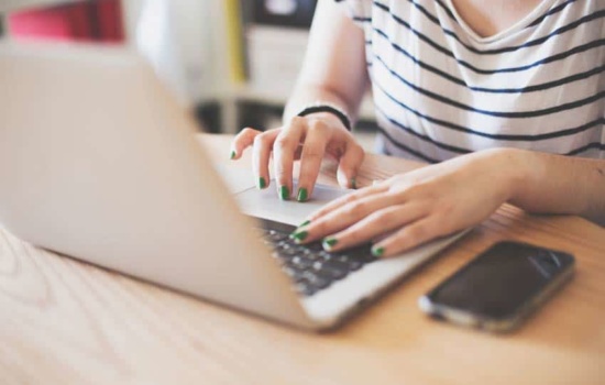 Music Blogger typing on her laptop