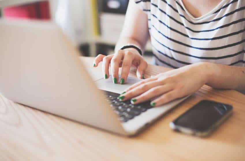 Music Blogger typing on her laptop