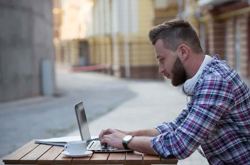 Music Critic working outdoors on his laptop