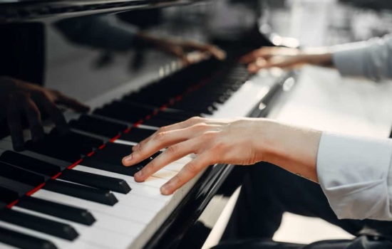 Close up on a Composer's hands playing the piano
