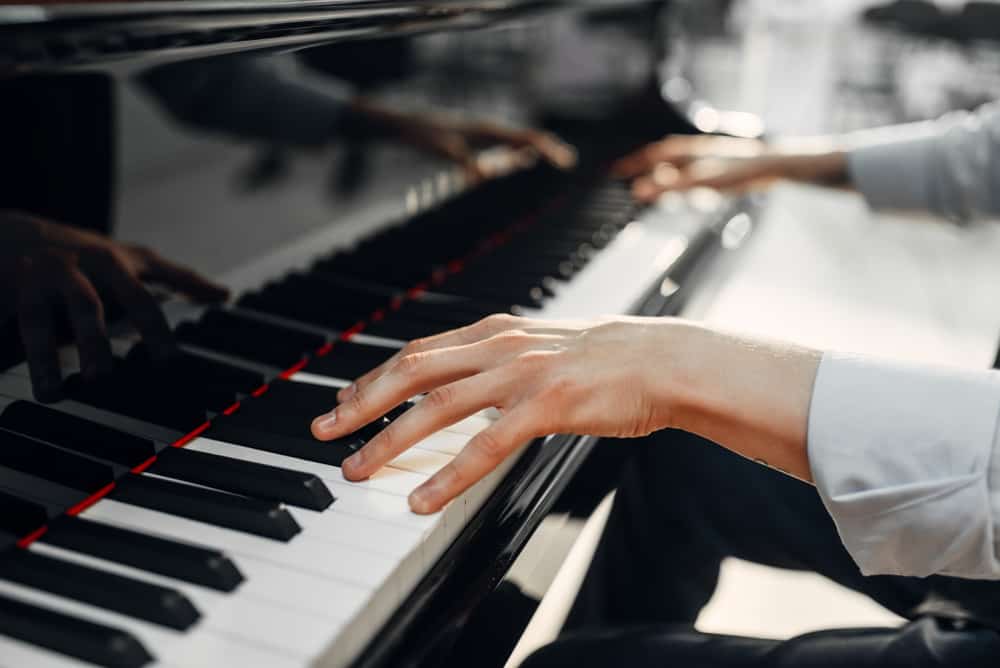 Close up on a Composer's hands playing the piano