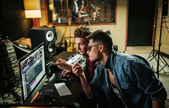 Two male Record Producers working in a music studio