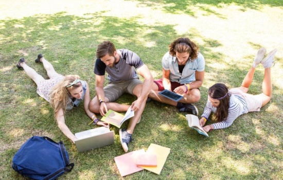 Music Business classmates sitting on campus lawn