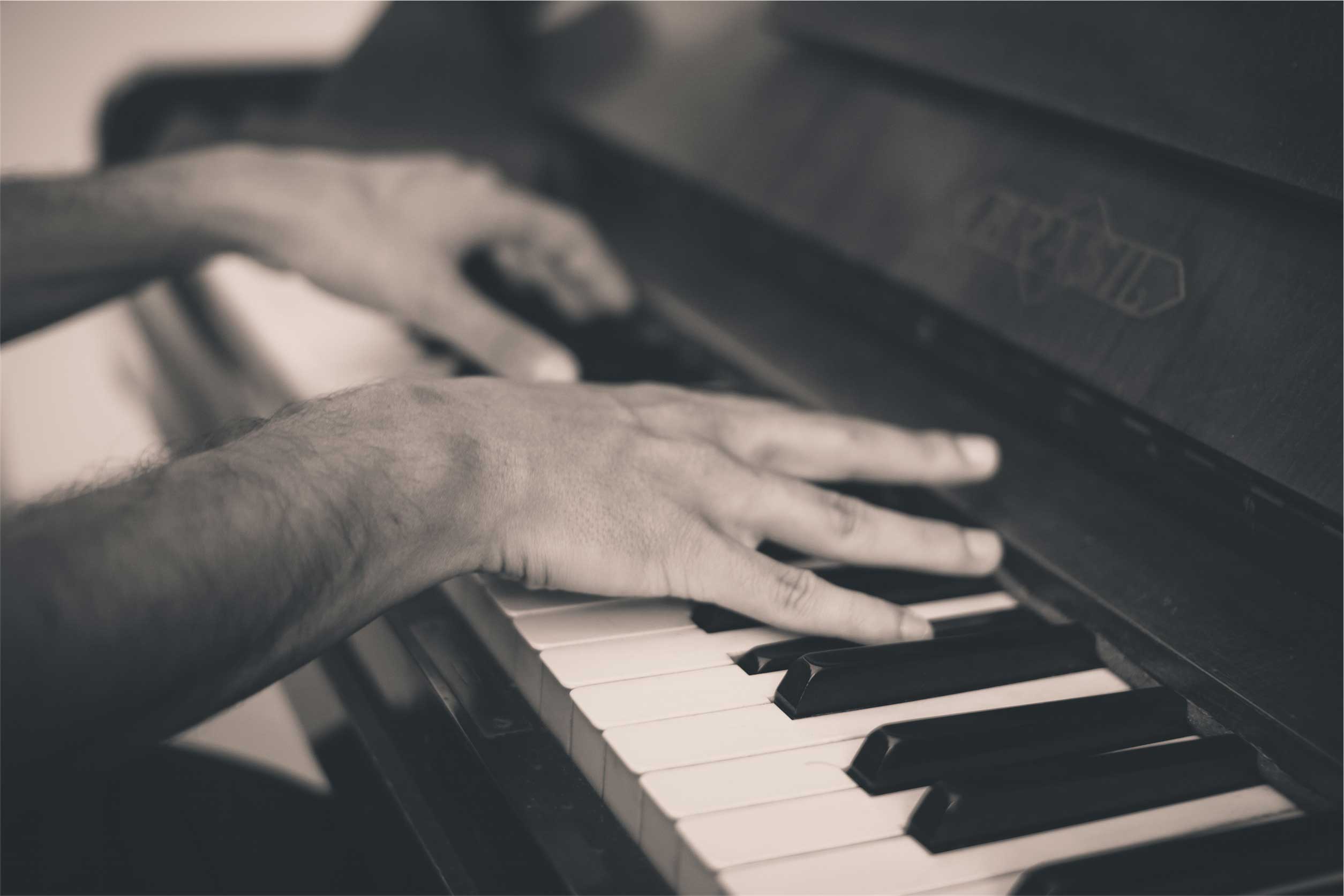 Closeup of hands playing a piano