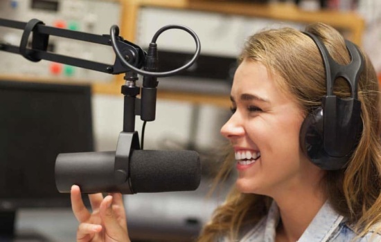 Laughing radio DJ in studio at college radio station