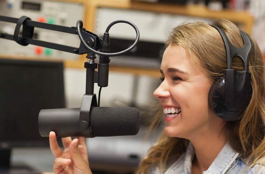Laughing radio DJ in studio at college radio station
