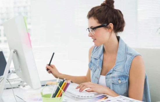 Marketing Coordinator reading the screen of her desktop computer