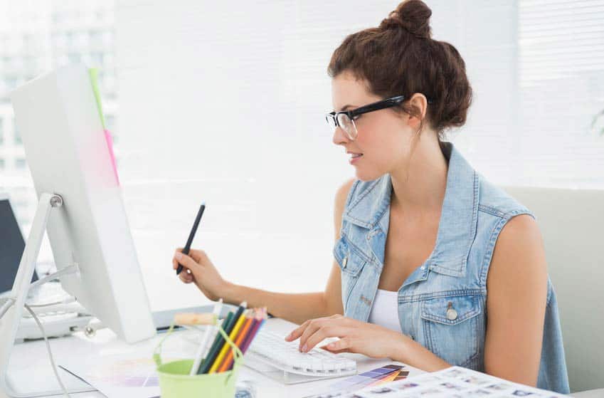 Marketing Coordinator reading the screen of her desktop computer