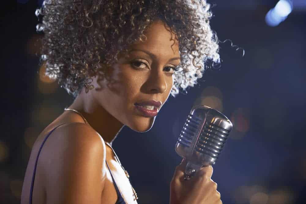 Female jazz singer holding microphone
