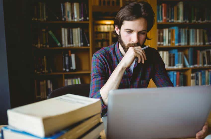 Music Historian doing research on a laptop in the library