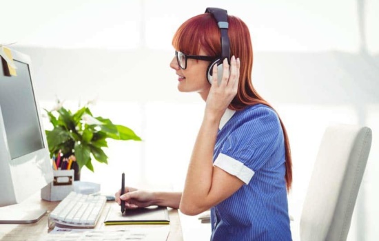 Licensing Representative listening to music on her desktop computer