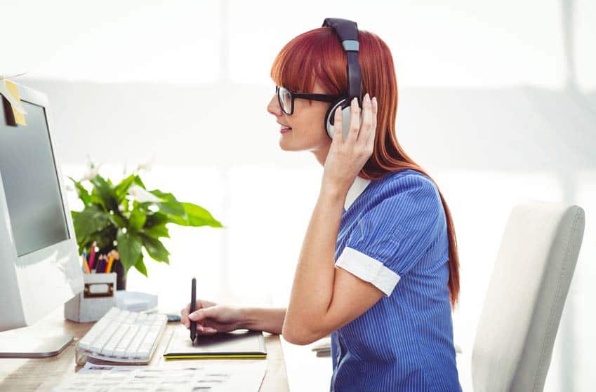 Licensing Representative listening to music on her desktop computer