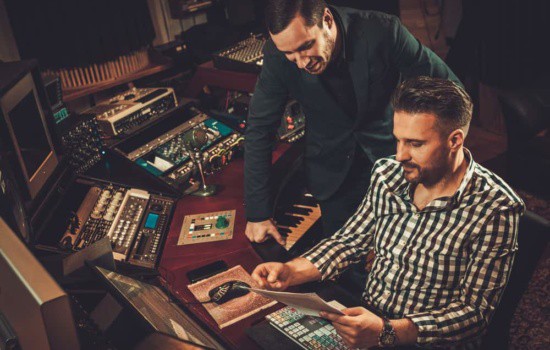 Sound engineers talking in recording studio