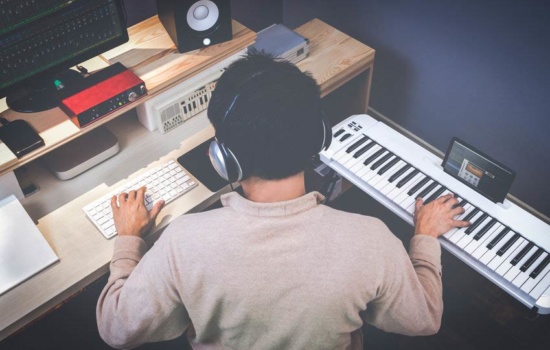 Music composer making songs in home recording studio