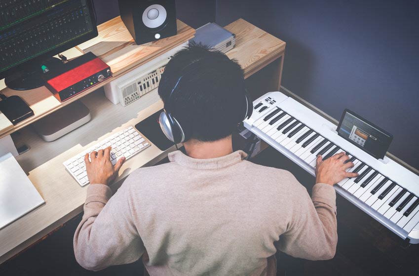 Music composer making songs in home recording studio
