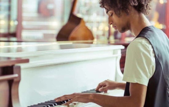 Young African-American musician playing his piano