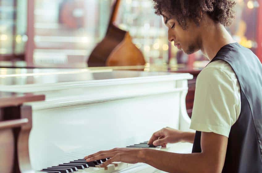 Young African-American musician playing his piano