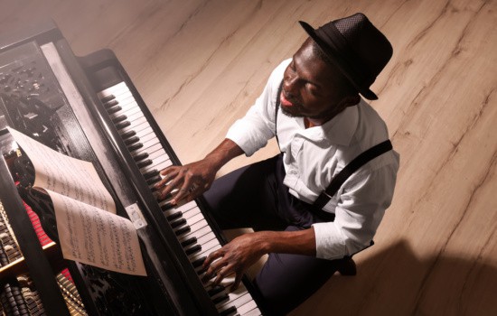 Accompanist playing piano in open studio space