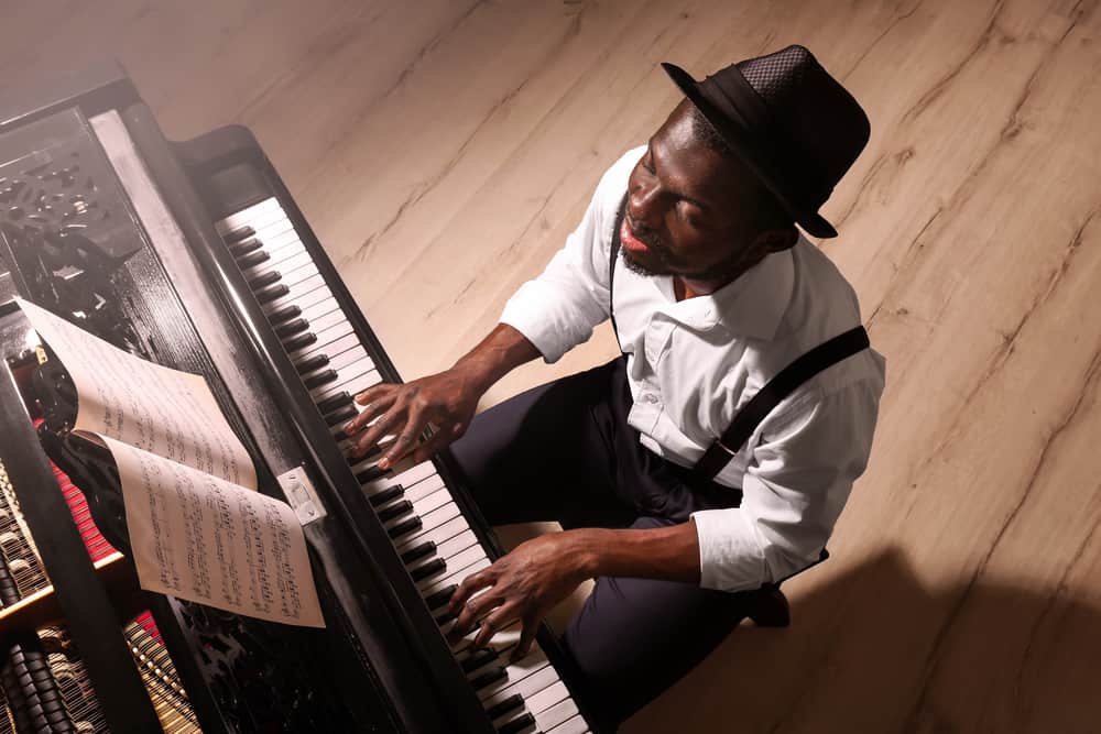 Accompanist playing piano in open studio space