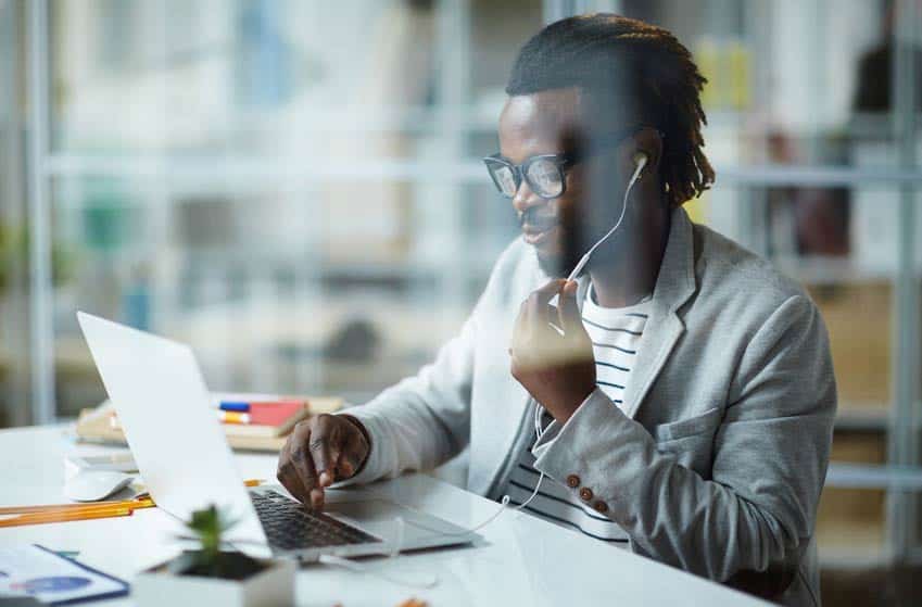 Talent Buyer listening to music on his earphones at the office