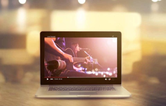 Laptop screen displaying a live concert on a social media channel