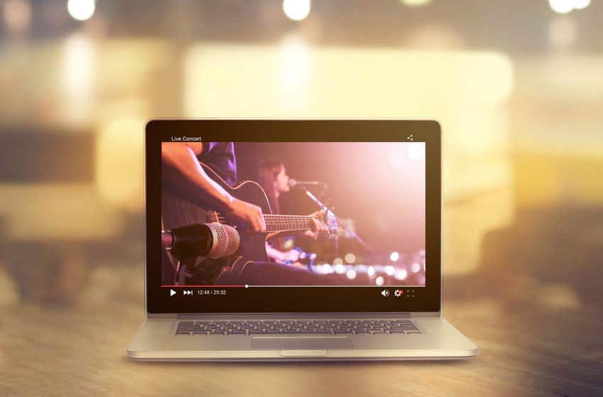 Laptop screen displaying a live concert on a social media channel