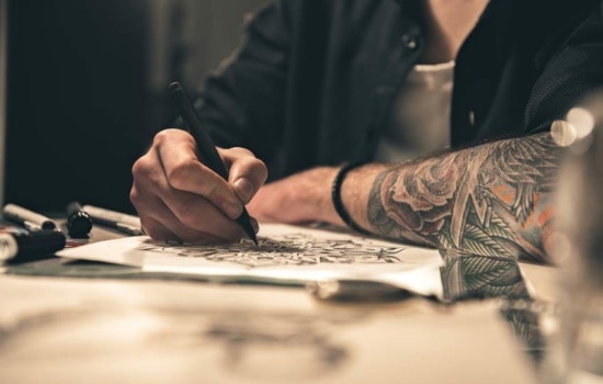 Album Cover Designer sketching art on a notepad