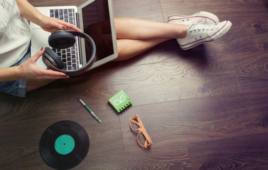 Young musician making her own music on her laptop