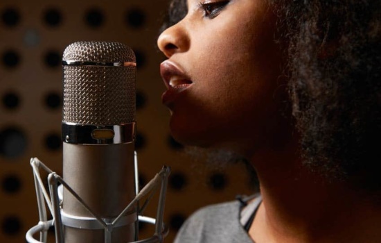 Female singer in closeup with vocal mic