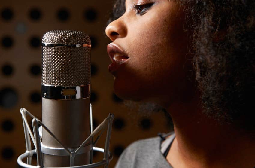 Female singer in closeup with vocal mic