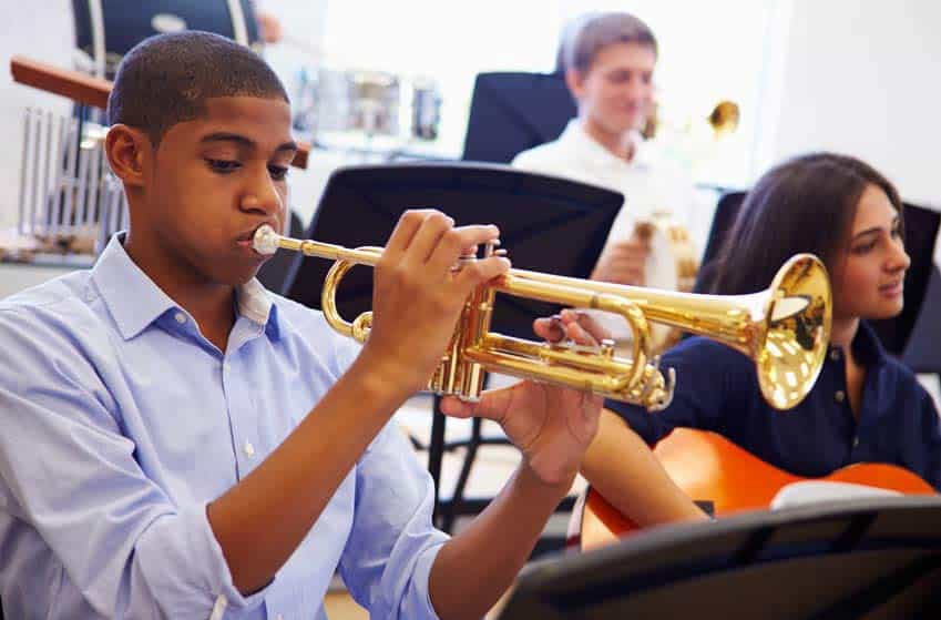 Young trumpet player performing in high school band